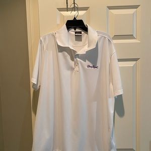 Nike golf polo with the crown royal logo stitched on it